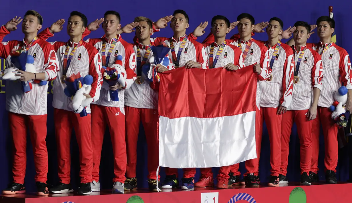 Pemain dan pelatih tim beregu putra Indonesia merayakan gelar juara cabang bulutangkis SEA Games 2019 di Multinlupa Sport Center, Rabu (4/12). Indonesia meraih emas setelah menang 3-1 atas Malaysia. (Bola.com/M Iqbal Ichsan)