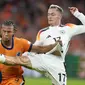 Penyerang Jerman Florian Wirtz mencoba tahan bola dari hadangan bek Belanda Nathan Ake pada laga grup 3 UEFA Nations League di Johan Cruyff Arena (AP)