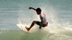 Seorang pria berselancar di pantai Kuta dekat Denpasar di pulau resor Indonesia di Bali (3/5). Pantai Kuta adalah sebuah tempat pariwisata yang terletak kecamatan Kuta, sebelah selatan Kota Denpasar, Bali, Indonesia. (AFP Photo/Sonny Tumbelaka)