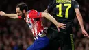 Striker Juventus, Mario Mandzukic berebut bola udara dengan bek Atletico Madrid, Juanfran selama pertandingan 16 besar Liga Champions di stadion Wanda Metropolitano, Madrid (20/2). Atletico menang 2-0 atas Juventus. (AP Photo/Manu Fernandez)