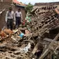 Petugas mengintruksikan Anjing pelacak K-9 saat menyisir reruntuhan bangunan rumah akibat banjir bandang di Kampung Bojong Sudika, Cimacan, Garut, Jumat (23/9). (Liputan6.com/Johan Tallo)