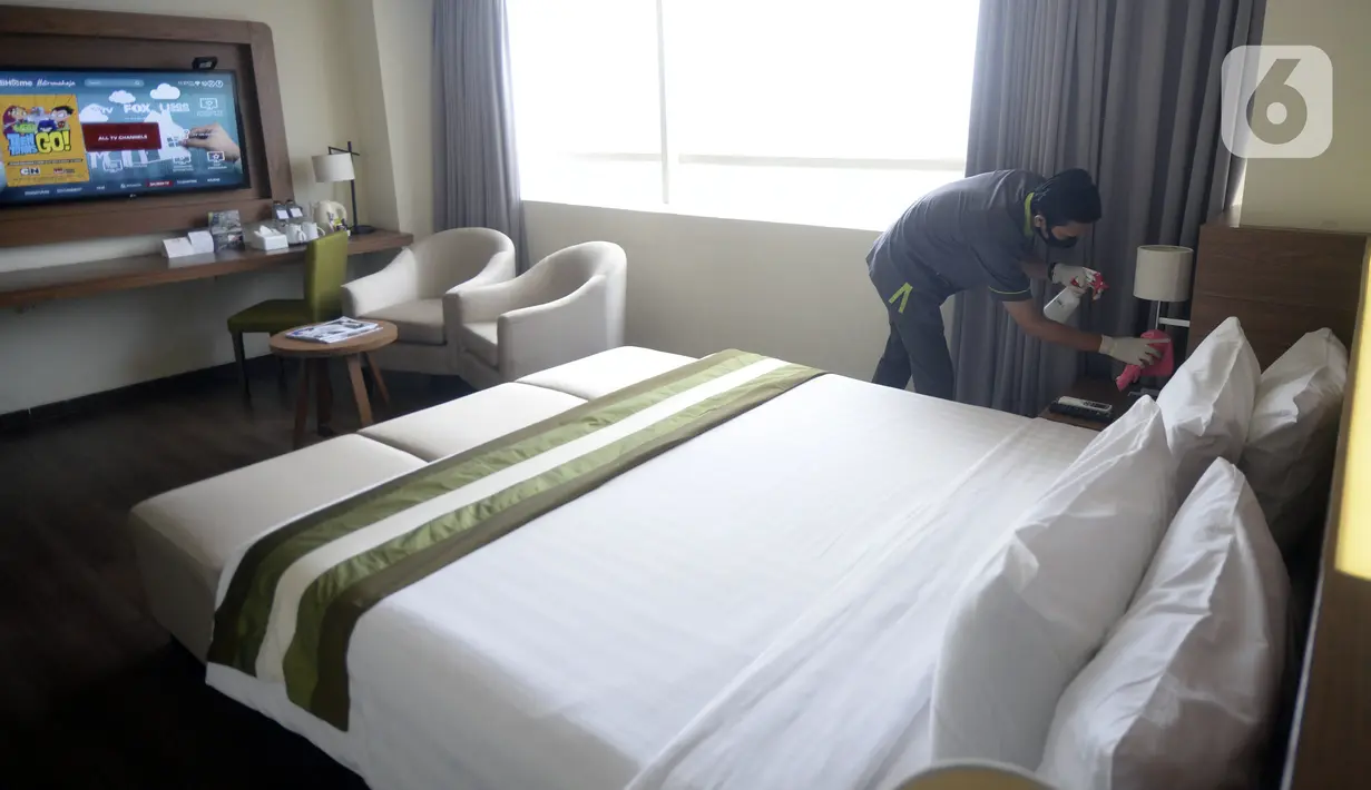 Pegawai melakukan penyemprotan disinfektan di kamar Hotel Grand Whiz Poins Simatupang, Jakarta, Kamis (16/4/2020). Hotel ini menyediakan paket isolasi mandiri untuk mendukung program pembatasan sosial berskala besar (PSBB) di tengah pandemi virus corona COVID-19. (merdeka.com/Dwi Narwoko)