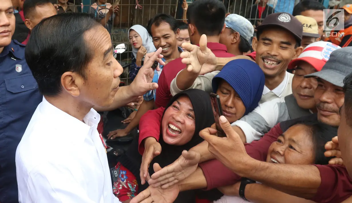 Presiden Joko Widodo atau Jokowi menyapa warga saat blusukan di Pasar Minggu, Jakarta, Jumat (22/2). Jokowi berada di Pasar Minggu hanya sekitar 20 menit. (Liputan6.com/Angga Yuniar)