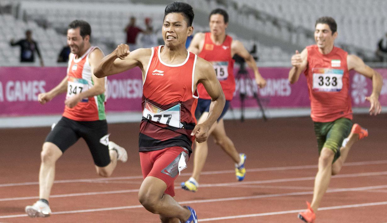 Purnomo Sapto Yogo pelari Indonesia meraih medali emas di nomor 100 meter putra klasifikasi T37 pada Asian Para Games 2018, di Stadion Utama Gelora Bung Karno Jakarta, Selasa (9/10/2018).  (Bola.com/Peksi Cahyo)