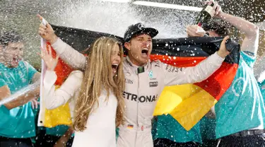 Pembalap tim Mercedes dari Jerman, Nico Rosberg bersama istrinya, Vivian merayakan kemenangan sebagai juara Formula 1 2016 di sirkuit Yas Marina di Abu Dhabi, Uni Emirat Arab, (27/11). (REUTERS/Ahmed Jadallah)