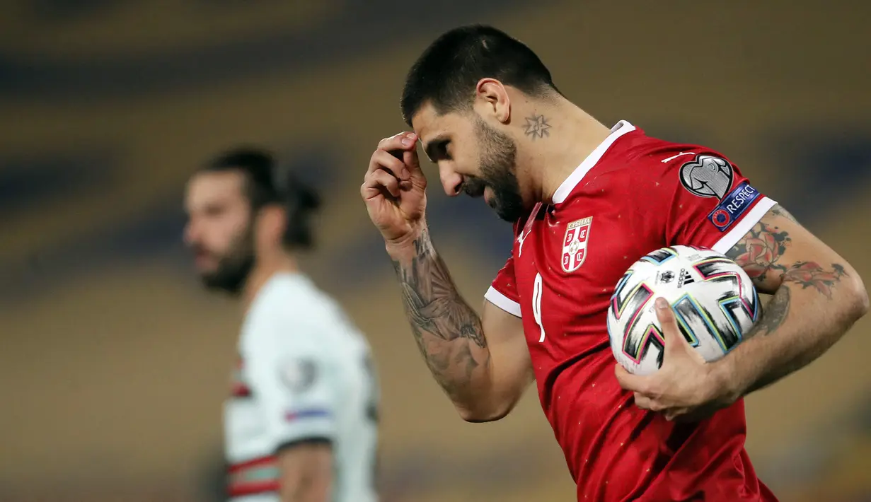 Striker Serbia, Aleksandar Mitrovic melakukan selebrasi usai mencetak gol pertama ke gawang Portugal dalam laga Kualifikasi Piala Dunia 2022 Zona Eropa Grup A di Rajko Mitic Stadum, Belgrade, Sabtu (27/3/2021). Serbia bermain imbang 2-2 dengan Portugal. (AFP/Pedja Milosavljevic)
