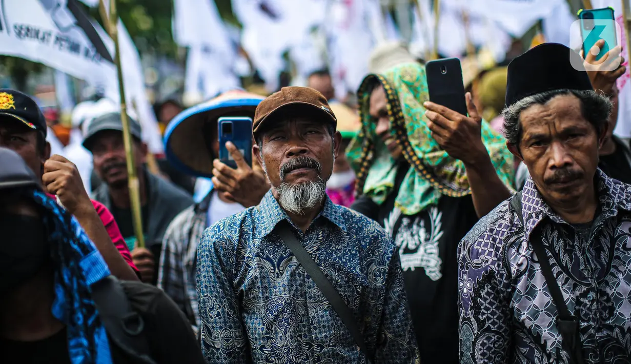 Sejumlah elemen masyarakat yang tergabung dalam buruh dan petani menggelar aksi di depan Gedung DPR, Jakarta, Selasa (27/9/2022). Aksi tersebut digelar tepat di momentum peringatan Hari Tani Nasional (HTN) 2022, 27 September. (Liputan6.com/Faizal Fanani)
