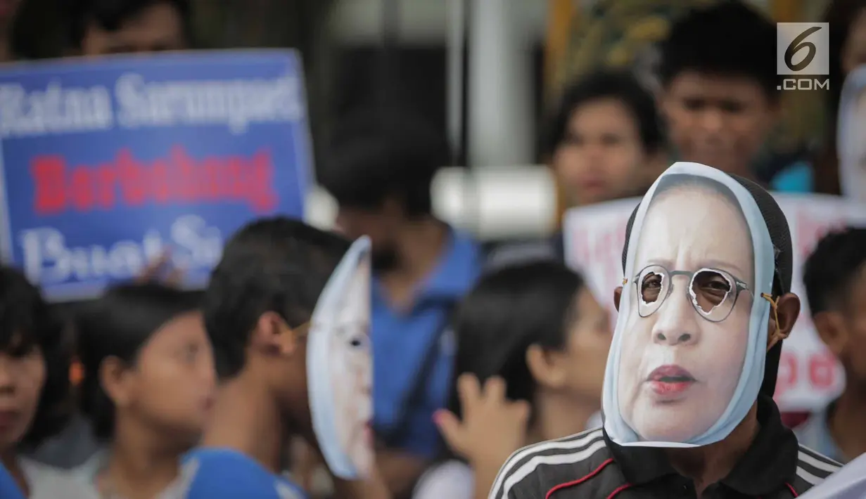 Massa Gerbang (Gerakan Anak Bangsa) mengenakan topeng bergambar  Ratna Sarumpaet  saat unjuk rasa di depan PN Jakarta Selatan, Selasa (19/3). Mereka meminta Ratna Sarumpaet membongkar aktor intelektual dalam penyebaran hoaks. (Liputan6.com/Faizal Fanani)