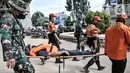 Petugas gabungan mengevakuasi korban dengan tandu saat simulasi penanganan banjir di Kalimalang, Cipinang Melayu, Rabu (17/11/2021). Simulasi digelar dalam rangka kesiapsiagaan petugas dalam penanganan korban banjir, terutama evakuasi warga yang terpapar Covid-19. (merdeka.com/Iqbal S Nugroho)