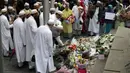 Sejumlah muslim meletakkan karangan bunga di Potters Field Park, London, Senin (5/6). Mereka mengenang dan mendoakan para korban serangan teror di London Bridge dan Borough Market yang menewaskan 7 orang dan melukai puluhan lainnya. (AP Photo/Tim Ireland)