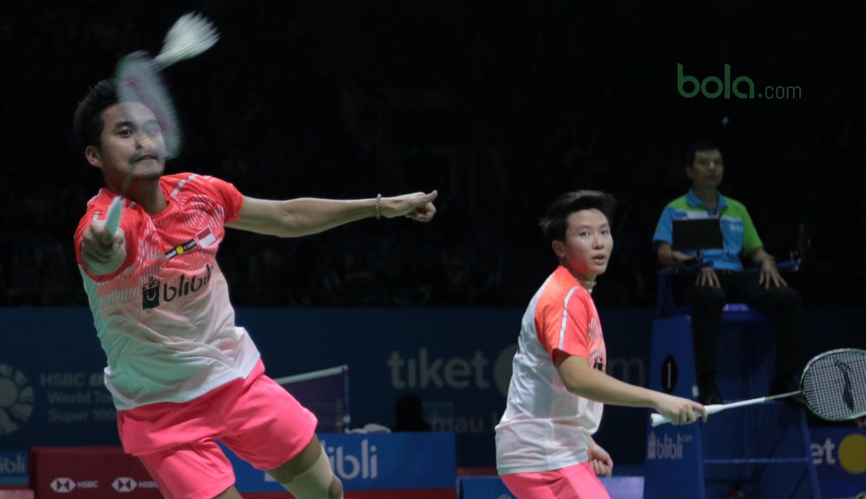 Tontowi Ahmad terbang saat mengembalikan kok ke arah pasangan Jepang, Yugo Kobayashi/Misaki Matsutomo pada babak kedua Indonesia Open 2018 di Istora Senayan, Jakarta, (5/6/2018). Tontowi/Liliyana menang 24-22, 21-19. (Bola.com/Nick Hanoatubun)