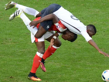 Pemain Prancis, Paul Pogba (atas), berebut bola dengan pemain Swiss, Breel Embolo, pada laga terakhir Grup A Piala Eropa 2016 di Stade Pierre Mauroy, Lille, Senin (20/6/2016) dini hari WIB. (AFP/Denis Charlet)