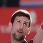 Petenis Serbia, Novak Djokovic menservis bola selama bertanding melawan Lucas Pouille dari Prancis usai di Tenis Jepang Terbuka 2019 di Ariake Coliseum, Tokyo, Jumat (4/10/2019). Djokovic menang dengan skor 6-1, 6-2 atas Pouille. (AFP Photo/Toshifumi Kitamura)