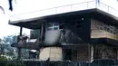 Dinding yang menghitam setelah kebakaran melanda Panti Asuhan Church of Bible Understanding di pinggiran Port-au-Prince di ibu kota Haiti, Jumat (14/2/2020). Dua anak tewas di lokasi, sementara 13 lainnya setelah sempat dirawat di rumah sakit. (AP/Dieu Nalio Chery)