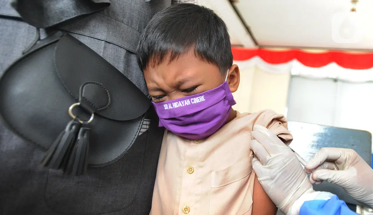 Siswa kelas 1 mendapatkan suntikan vaksin tetanus difteri (TD) di SDI Al Hidayah, Cinere, Depok, Jumat (20/11/2020). Program imunisasi kepada pelajar di Kota Depok terus berjalan guna menjaga kesehatan anak dan meningkatkan imunitas tubuh di masa pandemi COVID-19. (merdeka.com/Arie Basuki)