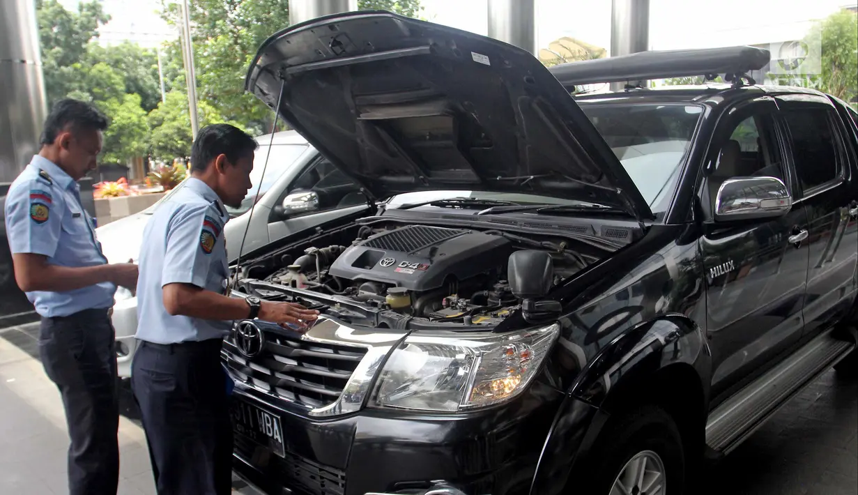 Pengecekan kondisi mobil sitaan oleh petugas Rumah Penyimpanan Benda Sitaan Negara (Rupbasan) Jakarta Utara di Gedung KPK, Jakarta, Selasa (30/1). KPK menyerahkan dua mobil  yang sebelumnya dimiliki terpidana kasus korupsi. (Liputan6.com/Herman Zakharia)