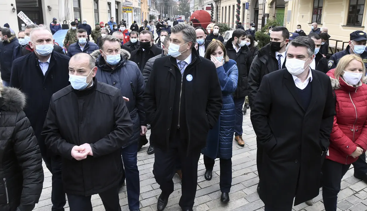 Perdana Menteri Kroasia Andrej Plenkovic, tengah dan Presiden Zoran Milanovic, kanan, memeriksa kerusakan yang disebabkan oleh gempa bumi di Sisak, Kroasia, Senin (28/12/2020). (AP Photo)