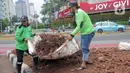 Petugas pasukan hijau dari Suku Dinas Perhutanan dan Taman Kota memindahkan tanaman yang rusak usai perayaan Tahun Baru 2024 di Bundaran HI. (merdeka.com/Arie Basuki)