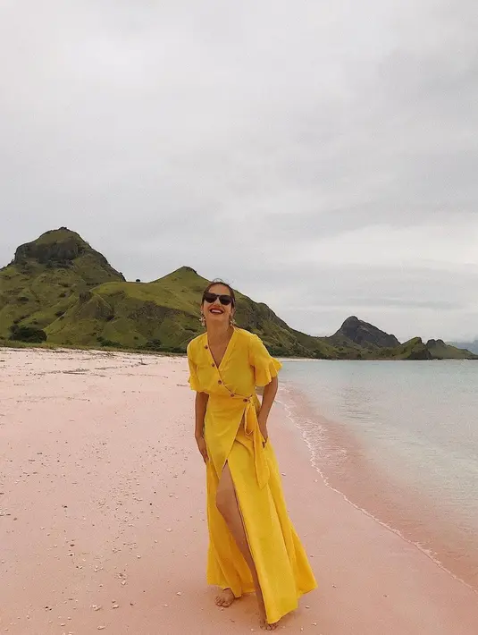 Untukmu yang ongin tampil stunning di pantai, kamu bjsa mengenakan dress dengan warna cerah. Tak lupa menambahkan sunglesses sebagai aksesoris wajib