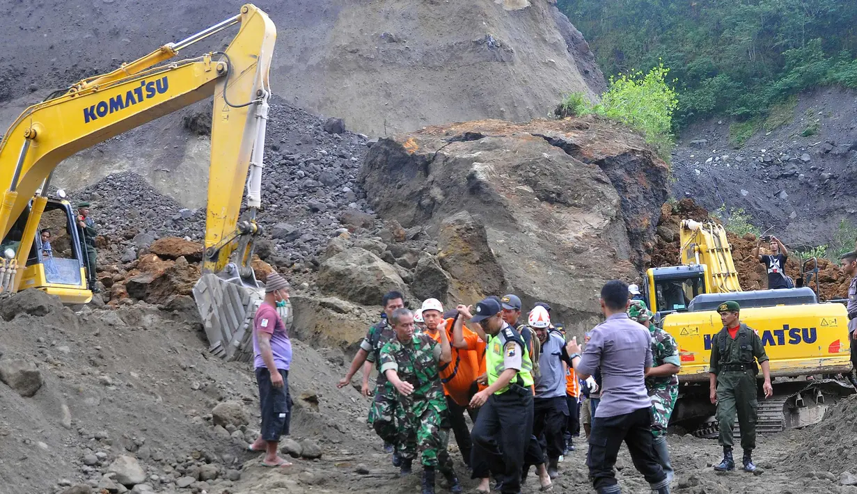 Petugas mengevakuasi korban tanah longsor di Magelang, Senin (18/12). Menurut pejabat setempat, delapan penambang tewas akibat longsor di lereng gunung berapi di pulau Jawa. (AFP Photo)