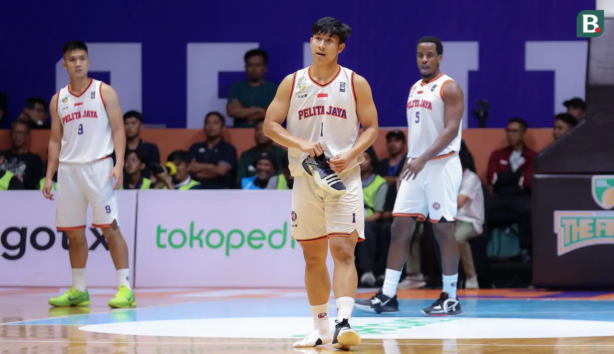 Pebasket Pelita Jaya, Muhamad Arighi memungut sepatunya pada laga gim pertama final IBL 2023 di Hall Senayan, Jakarta, Kamis (20/07/2023). Laga dimenangkan oleh Prawira Bandung dengan skor 74-65. (Bola.com/Bagaskara Lazuardi)