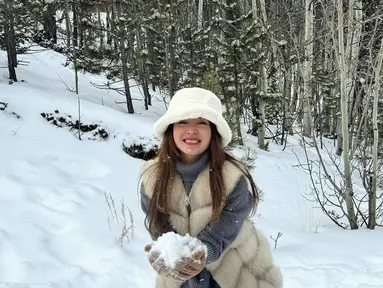 Mengunjungi Colorado Springs, Colorado, Amerika Serikat, Natasha Wilona tampil stylish dengan jaket berbulu tebal putihnya. Penampilannya yang menawan ini menuai banyak pujian netizen. Apalagi pose lucunya saat bermain salju ini banyak menuai perhatian para penggemar. (Liputan6.com/IG/@natashawilona12)