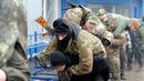 Warga sipil melakukan penyelamatan prajurit yang terluka saat mengikuti sesi pelatihan militer oleh Right Sector dekat Lviv, Ukraina, 24 Februari 2023. (AP Photo/Mykola Tys)