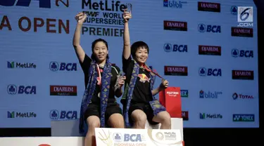 Ganda putri China Chen Qingchen dan Jia Yifan mengangkat trofi usai memenangkan final kejuaraan BCA Indonesia Open 2017 di Jakarta, Minggu (18/6). Chen Qingchen dan Jia Yifan menang dengan skor 21-19, 15-21, 21-10. (Liputan6.com/Faizal Fanani)