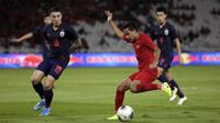 Gelandang Timnas Indonesia, Evan Dimas, adu skill dengan pemain Thailand dalam laga Kualifikasi Piala Dunia 2022 yang dihelat di SUGBK, Selasa (10/9/2019). Tim Merah-Putih kalah 0-3. (Bola.com/Vitalis Yogi Trisna)