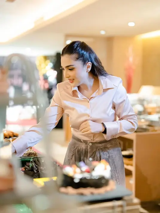 Ashanty terlihat manis kenakan kemeja satin pink yang dipadukan dengan setelan rok panjang dan jaket [@ashanty_ash]