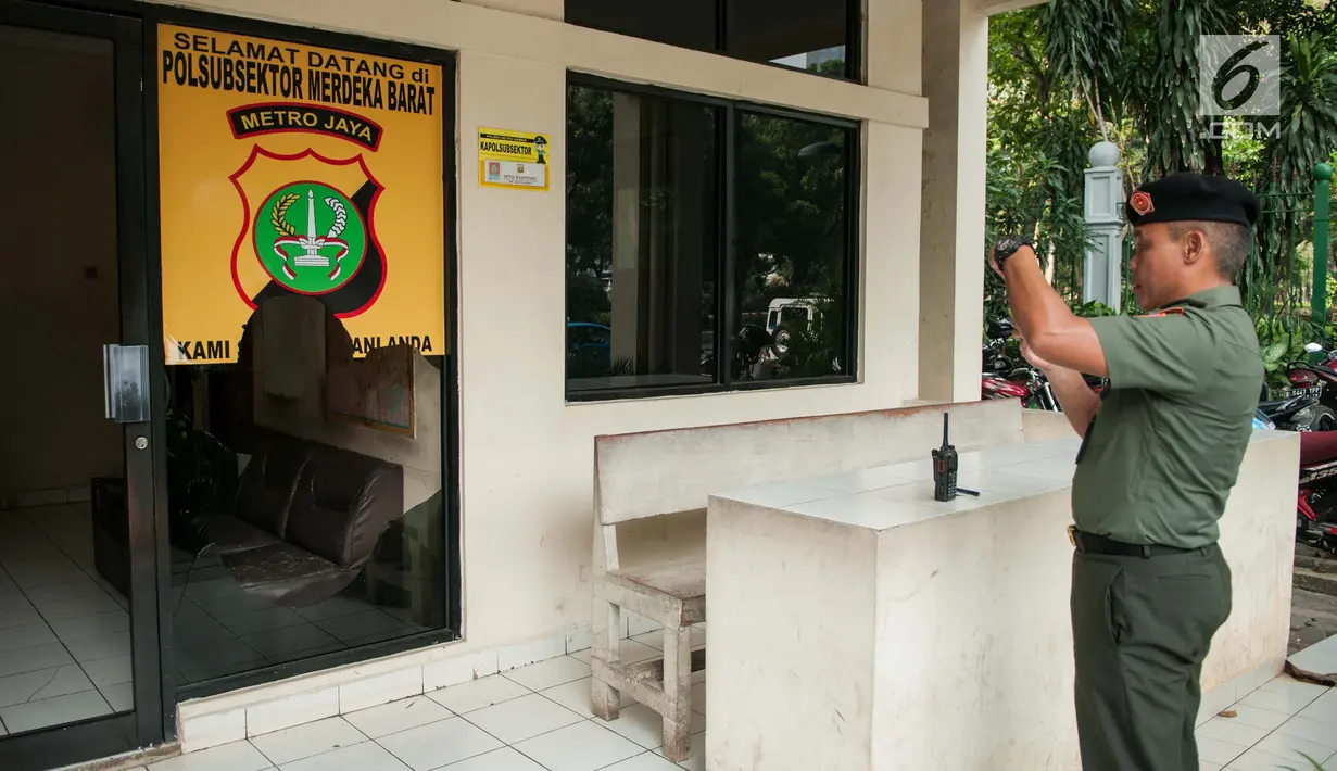 Petugas mengabadikan Pos Polisi Subsektor Monas Barat, Gambir, Jakarta, Jumat (26/5). Pengrusakan terjadi pada kamis malam tersebut diduga oknum yang mengaku sebagai aparat. (Liputan6.com/Gempur M Surya)