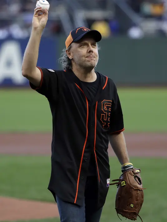 Pentolan Metallica, Lars Ulrich mengangkat tangannya kepada penonton usai melakukan lemparan pertama pada laga MLB antara San Francisco Giants melawan Chicago Cubs di San Francisco, (7/8/2017). San Francisco kalah 3-5 dari Cubs. (AP/Marcio Jose Sanchez)