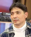 Abimana Aryasatya mengenakan kemeja Flannel kotak berwarna biru kuning lengan panjang di bagian luar. Abimana tampil stylish berpadu dengan pullover fleece kerah tinggi, dan celana jeans damage serta sepatu boots. [Foto: Fimela.com/Bambang E Ros]