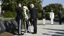 Presiden AS Donald Trump meletakkan karangan bunga usai peringatan serangan 11 September 2001 di Pentagon Memorial, Washington, Senin (11/9). Serangan itu menewaskan sekitar 3.000 orang dan hampir semua dimakamkan di sana. (Brendan Smialowski/AFP)