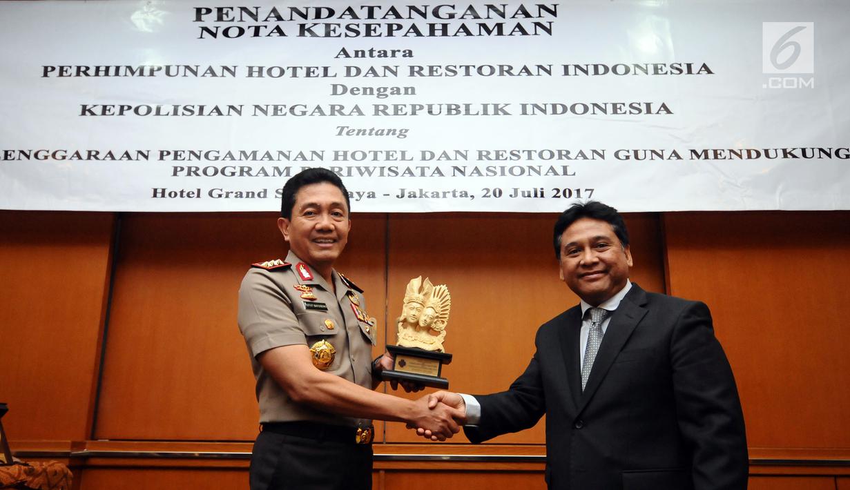 Kabaharkam Polri, Komjen Pol Putut Eko Bayuseno (kiri) bersama Ketua Umum PHRI, Hariyadi B.S.S bertukar cenderamata usai menandatangani MoU di Jakarta, Kamis, (20/7). MoU tentang Pengamanan Hotel dan Restoran. (Liputan6.com/Helmi Fithriansyah)