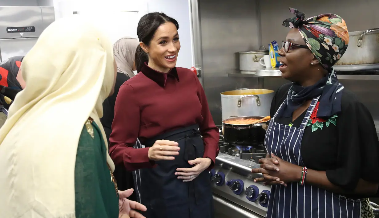 Duchess of Sussex Meghan Markle berbincang dengan anggota komunitas Hubb Community Kitchen di London, Inggris (21/11). Komunitas Hubb Community Kitchen ini mayoritas beragama Islam. (Chris Jackson/Pool via AP)