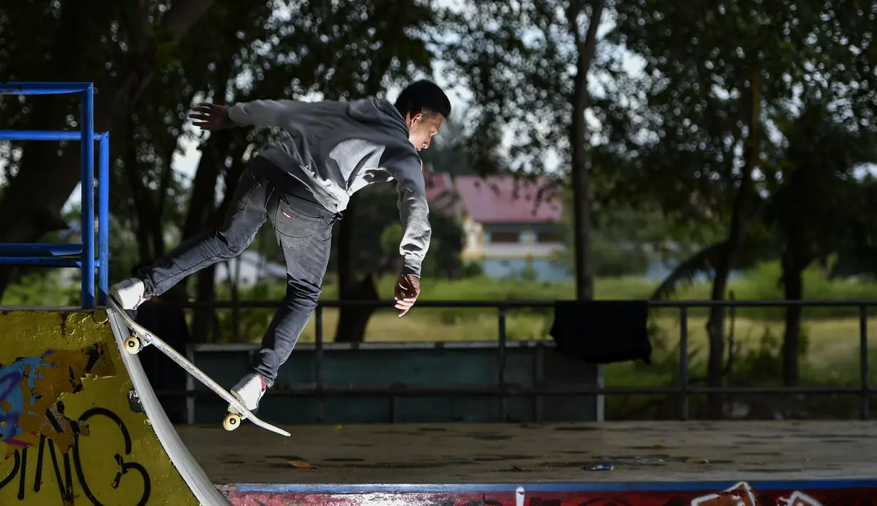 Seorang pemain skateboard melakukan trik di taman skate di Banda Aceh  (8/11/2020). (AFP/Chaideer Mahyuddin)