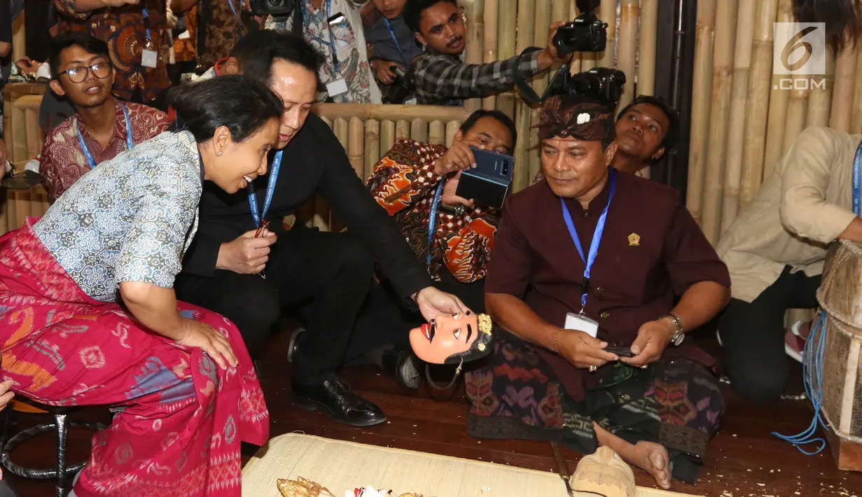 Menteri BUMN Rini Soemarno bersama Kepala Bekraf Triawan Munaf mengunjungi salah satu stand milik perusahaan BUMN selama ajang Pertemuan Tahunan IMF-World Bank Group 2018 di Nusa Dua Bali, Selasa (9/10). (Liputan6.com/Angga Yuniar)