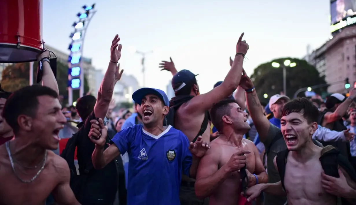 Fans legenda sepak bola Argentina Diego Maradona berkumpul untuk memberi penghormatan pada hari kematiannya di Obelisk, Buenos Aires, Argentina, 25 November 2020. Argentina mengumumkan tiga hari berkabung nasional atas meninggalnya Diego Maradona. (RONALDO SCHEMIDT/AFP)