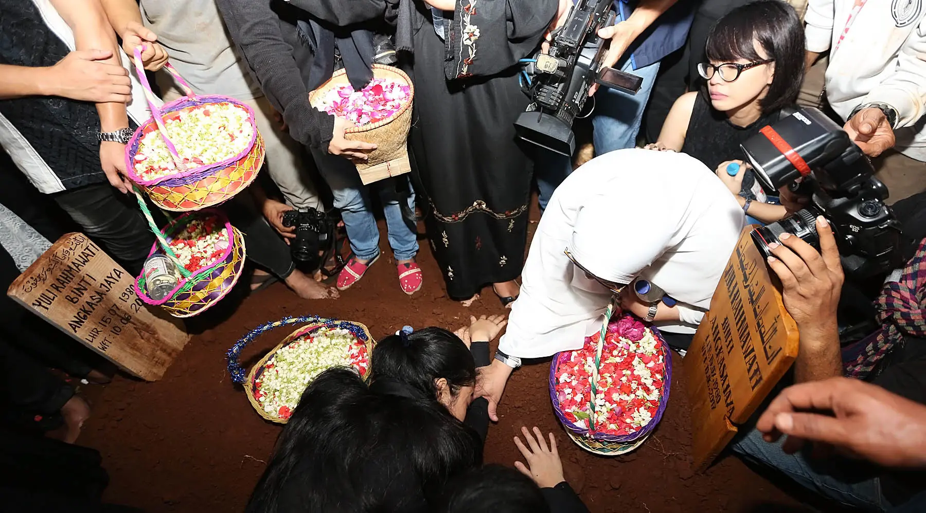 Terlihat ibunda dan kedua adik Jupe, Della dan Nia, tak kuasa menahan kesedihannya. Bahkan tanpa disadarinya, Della menangis sambil memeluk dan mengais-ngais bunga di atas makam kakak tercintanya. (Bambang E.Ros/Bintang.com)