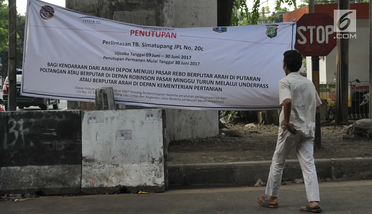 Spanduk pemeberitahuan penutupan perlintasan kereta Tanjung Barat, Jakarta Selatan, Jumat (16/7). Dinas Perhubungan dan Transportasi DKI menutup permanen perlintasan sebidang di Tanjung Barat untuk mengurangi kemacetan. (Liputan6.com/Yoppy Renato)
