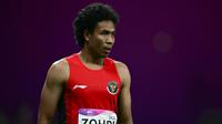 Pelari asal Indonesia, Lalu Muhammad Zohri bereaksi usai berlaga pada final 100m putra Asian Games 2023 di Hangzhou, Provinsi Zhejiang, China, Sabtu (30/9/2023). (Manan VATSYAYANA/AFP)