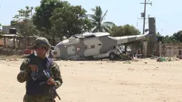 Tentara berjaga dekat helikopter milter UH-60 Black Hawk yang jatuh di Santiago Jamiltepec, negara bagian Oaxaca, Meksiko, Sabtu (17/2). Helikopter itu berada di Oaxaca untuk melihat kerusakan akibat gempa 7,5 SR. (AP/Luis Alberto Cruz Hernandez)