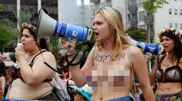 Seorang wanita peserta pawai "SlutWalk" tahunan berorasi di kota pantai Mediterania Israel Tel Aviv (4/5). Mereka memprotes budaya pemerkosaan dan pelecehan seksual yang ditujukan pada wanita. (AFP Photo/Jack Guez)