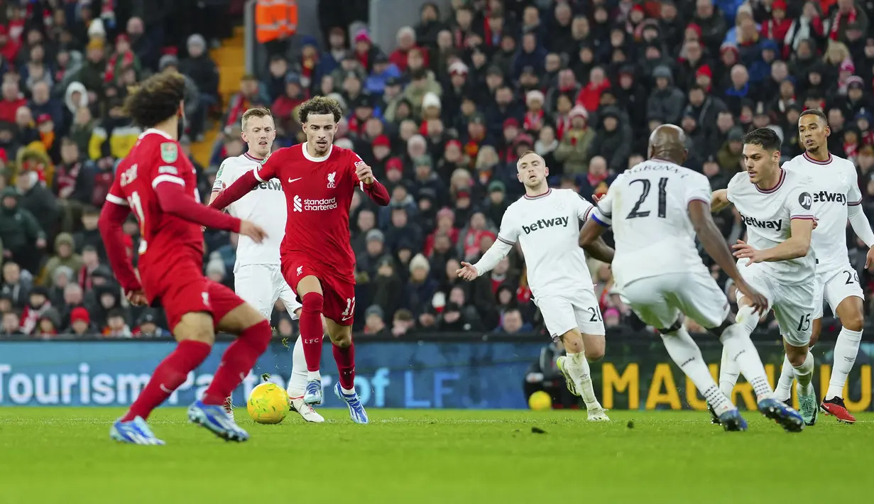 Pemain Liverpool, Curtis Jones (ketiga kiri) menggiring bola melewati sejumlah pemain West Ham United pada laga perempat final Carabao Cup 2023/2024 di Anfield, Liverpool, Inggris, Kamis (21/12/2023) dini hari WIB. (AP Photo/Jon Super)