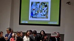 Sejumlah pegawai Christie saat proses lelang lukisan karya Pablo Picasso berjudul ‘Women of Algiers’ di Balai Lelang Christie, New York, Senin (11/5). Lukisan itu terjual seharga 179,3 juta dolar AS atau sekitar Rp 2,36 triliun. (REUTERS/Carlo Allegri)
