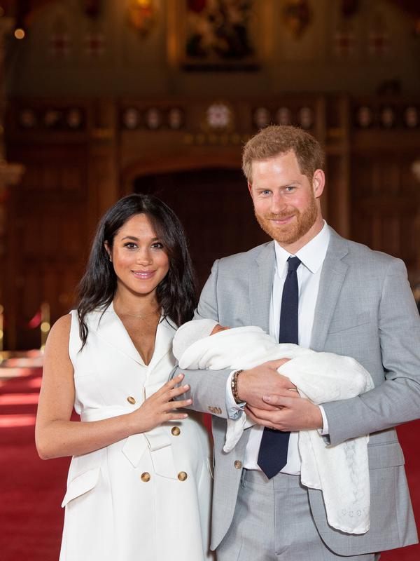 Pangeran Harry dan Meghan Markle berpose  dengan bayi laki-lakinya yang baru lahir di St George's Hall di Windsor Castle di Windsor, London (8/5/2019). Pangeran Harry dan Meghan Markle melahirkan anak pertama mereka di Frogmore Cottage pada Senin pagi, 6 Mei 2019.  (AFP Photo/Dominic Lipinski)