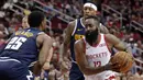 Pebasket Houston Rockets, James Harden, berusaha melewati pemain Denver Nuggets, Malik Beasley, pada laga NBA di Toyota Center, Selasa (8/1). Houston Rockets menang 125-113 atas Denver Nuggets. (AP/Michael Wyke)