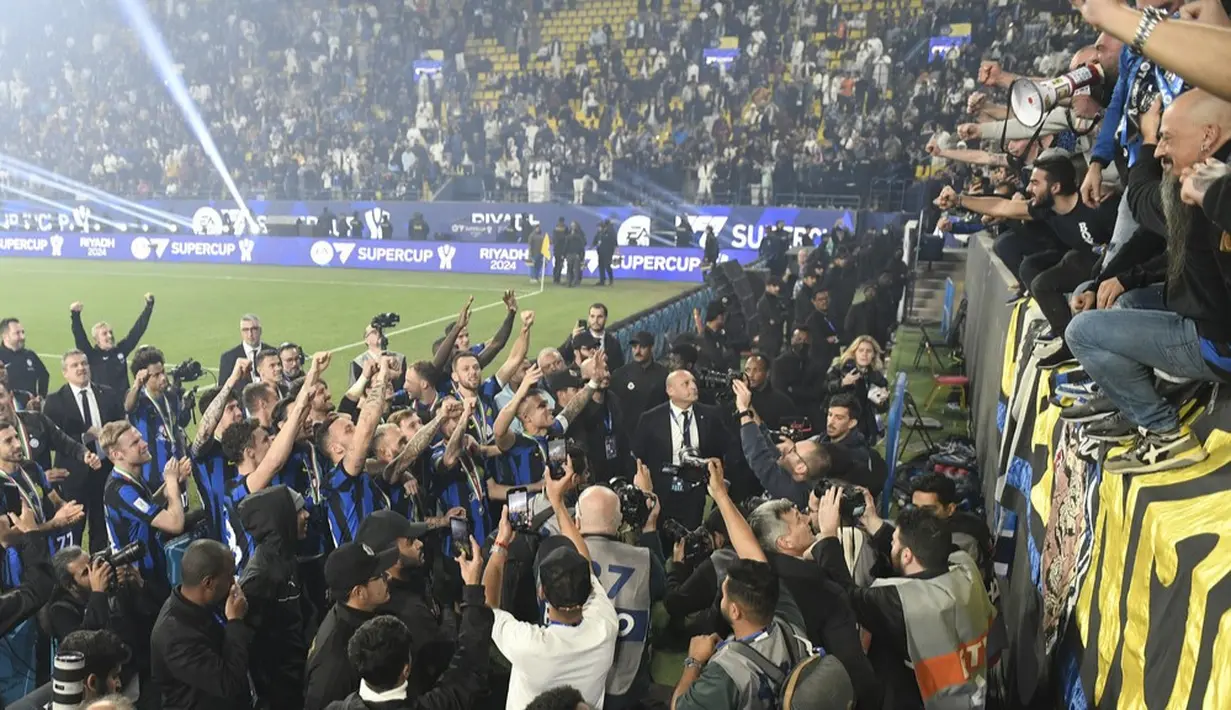 Para pemain Inter Milan bersama suporter merayakan keberhasilan menjuarai Piala Super Italia di Stadion Al-Awwal Park, Riyadh, Selasa (23/1/2024). Berkat hasil ini, Inter Milan pun meraih gelar Piala Super Italia kedelapan mereka sepanjang sejarah, sekaligus hat-trick alias gelar ketiga secara beruntun. (AP Photo)