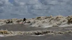 Peselancar Brasil Naysson Costa mengendarai gelombang pasang surut yang dikenal sebagai Pororoca saat Festival Selancar Amazon yang diadakan di Canal do Perigoso atau Saluran Berbahaya di muara Sungai Amazon dekat Chaves, Pulau Marajo, Negara Bagian Para, Brasil, Senin (5/6/2023). (AP Photo/Eraldo Peres)